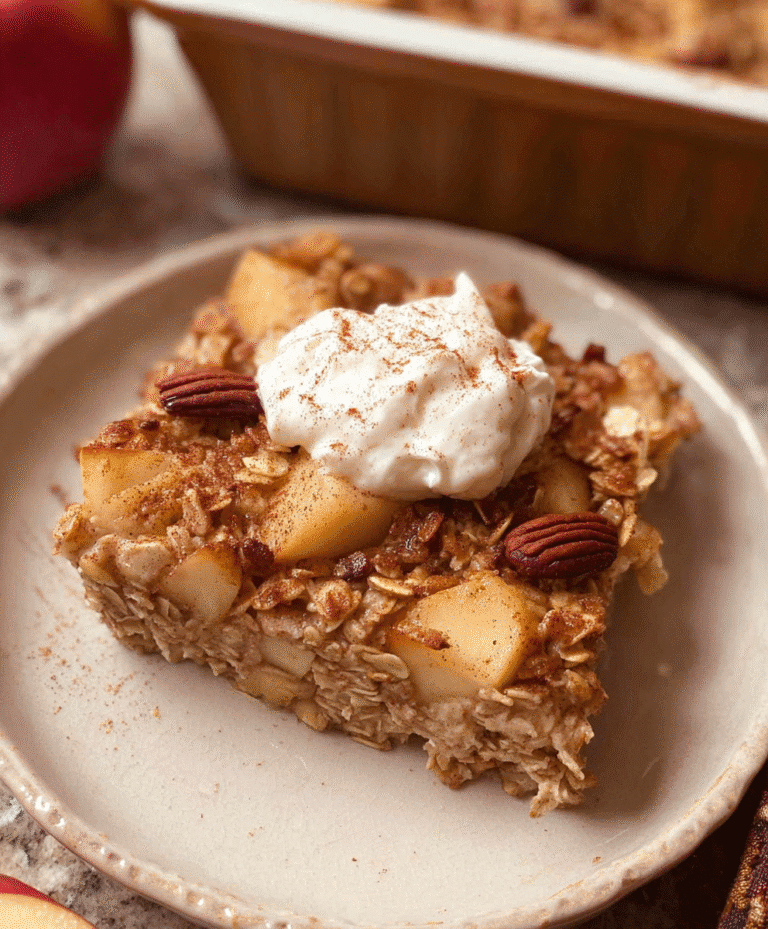 Baked apple oatmeal bar topped with whipped cream and pecans