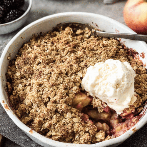 Healthy apple crumble topped with vanilla ice cream and oat streusel