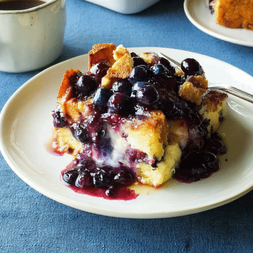 Overnight blueberry French toast casserole topped with warm blueberry sauce