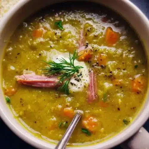 Bowl of delicious split pea soup garnished with herbs and spices